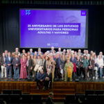 Foto de familia de las autoridades y participantes en el acto, con estudiantes actuales y pasados del programa.